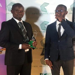 Anthony Opil, Senior Architect with the CORE trophy for Architecture Firm of the Year and Mark Mwoka, Candidate Architect.